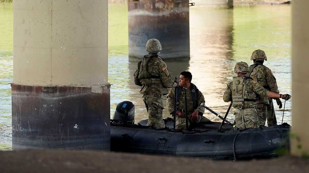 Texas National Guard members in boat on Rio Grande