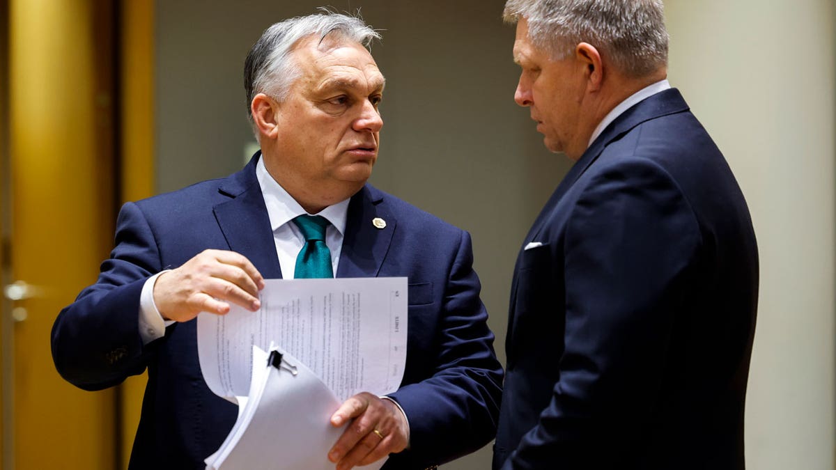 Slovakia's Prime Minister Robert Fico, right, talks to Hungary's Prime Minister Viktor Orban
