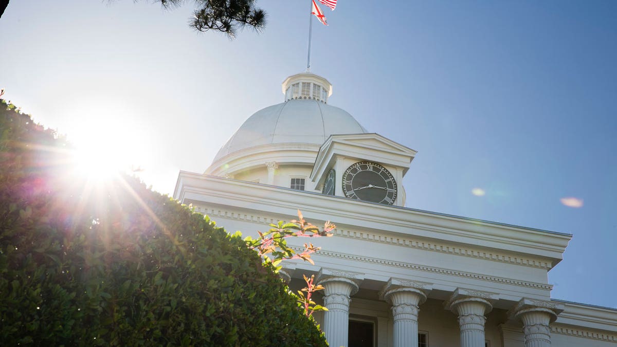 Sun peeking out from behind the Alabama State Capitol