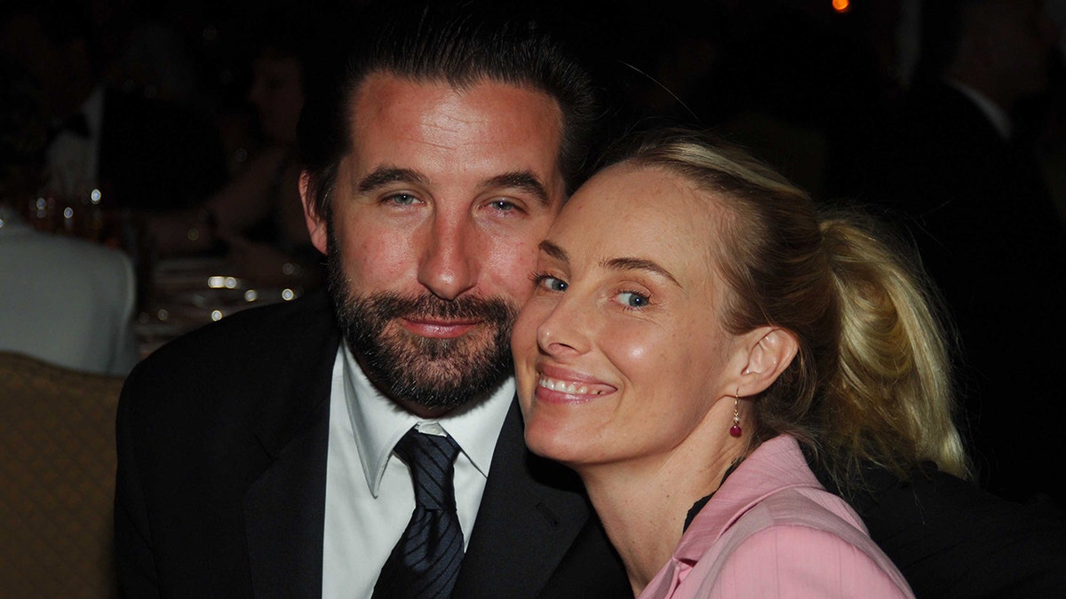 Billy Baldwin and Chynna Phillips clasp their faces adjacent for a photo