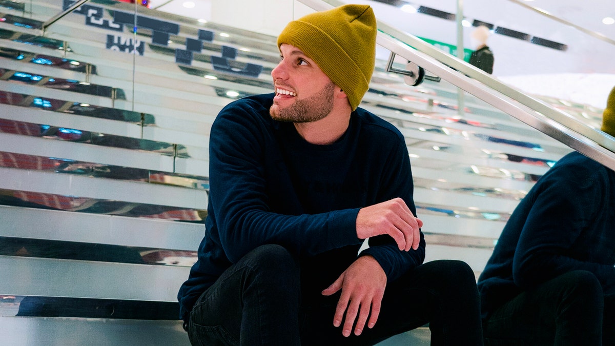 Chris Worthington sitting on stairs