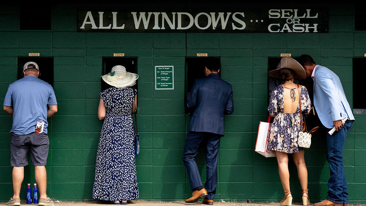 Horse racegoers place bets 