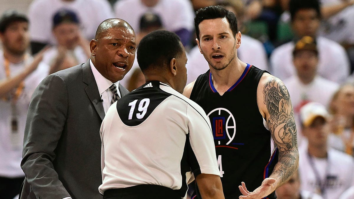 Doc Rivers and JJ Redick talk during a game