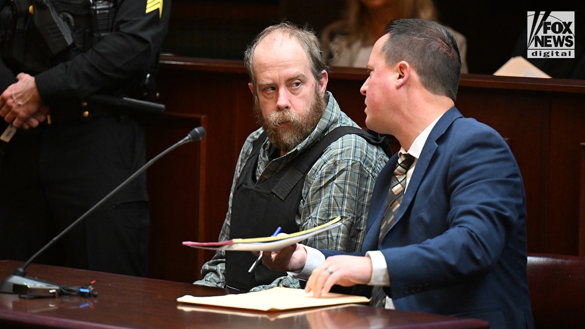 Craig Nelson Ross Jr., left, speaks with his defense attorney Matthew Maiello