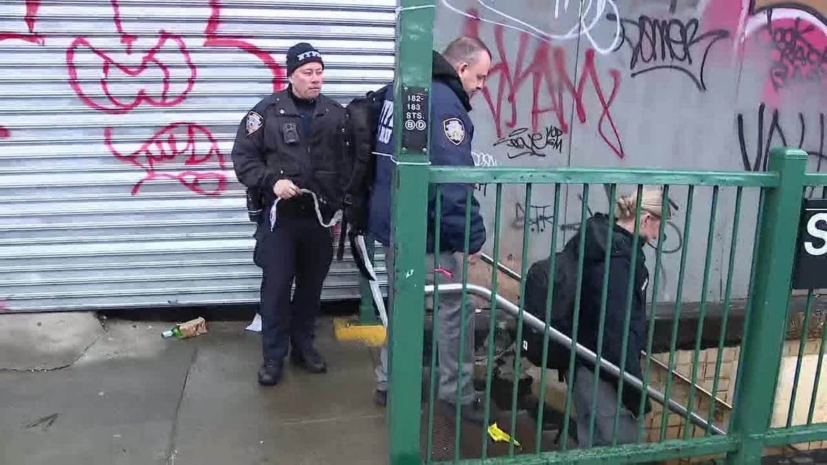 An NYPD officer can be seen outside the 182-183rd St. Station in the Bronx soon after a 45-year-old man was shot dead.