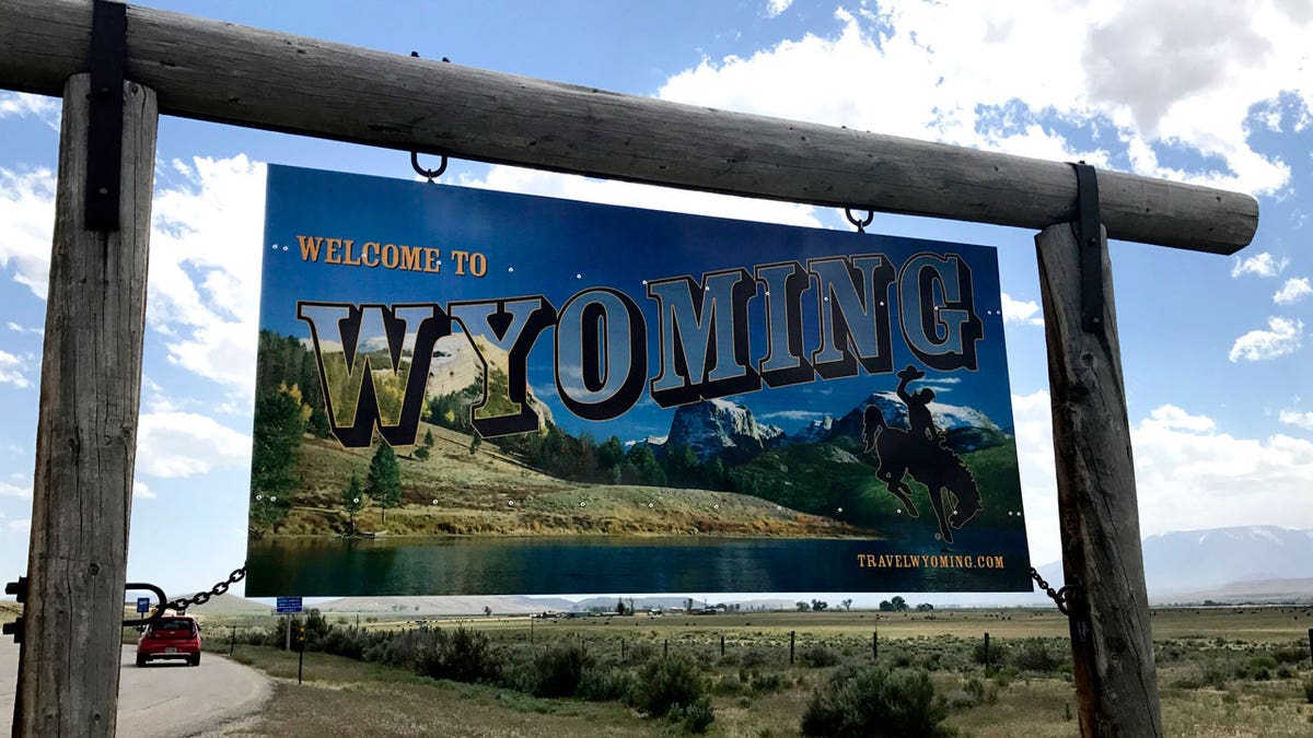 A "Welcome to Wyoming sign" on state line with Montana