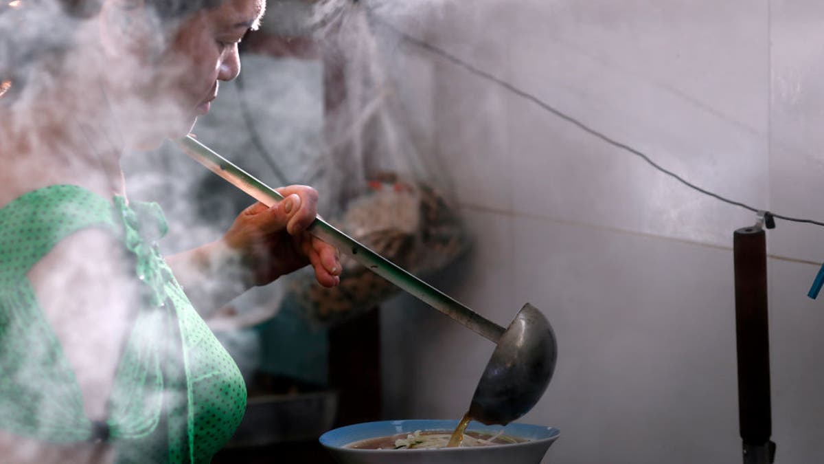 Woman cooking the Vietnamese tradional pho