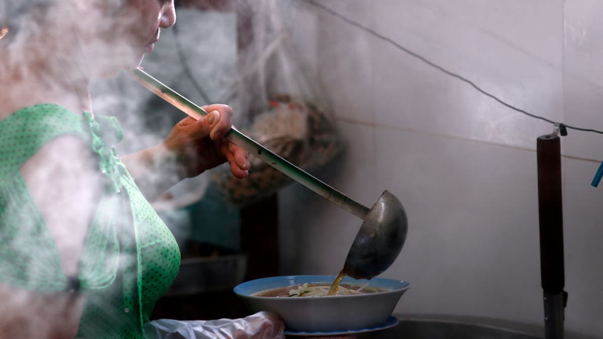 Woman cooking the Vietnamese tradional pho