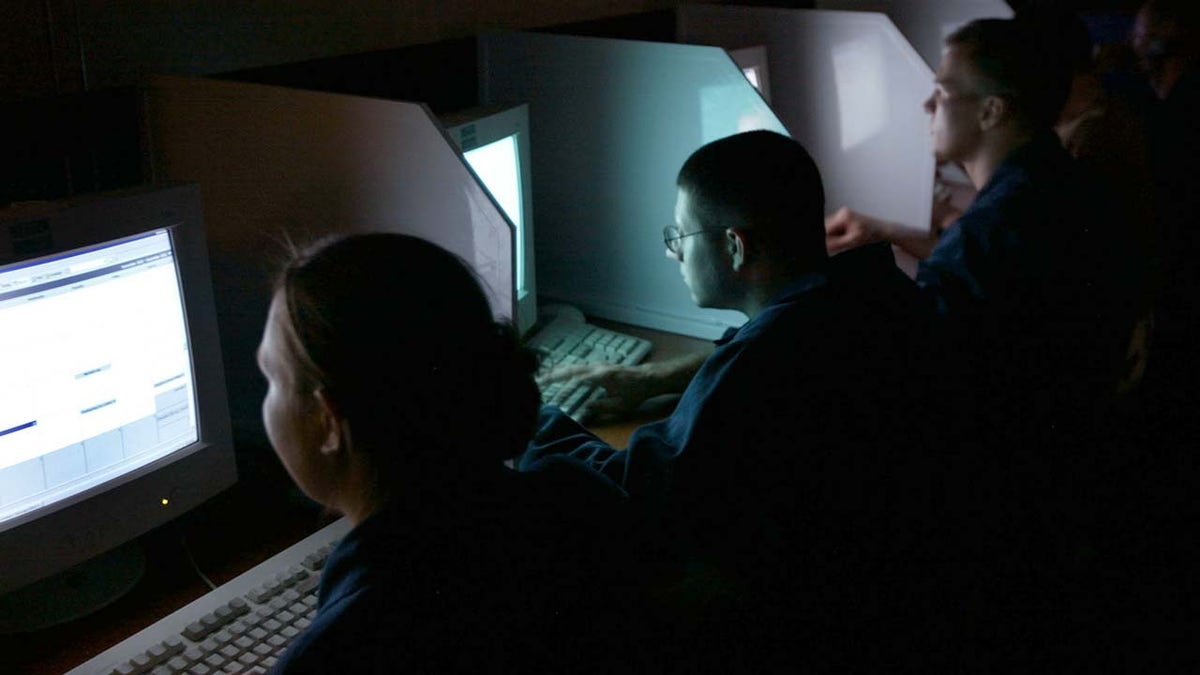 Naval members in front of computers