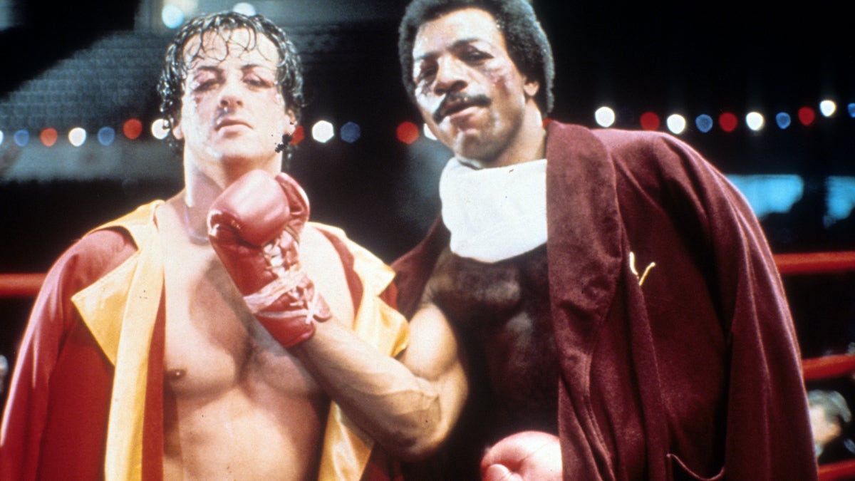sylvester stallone carl weathers posing together in rocky