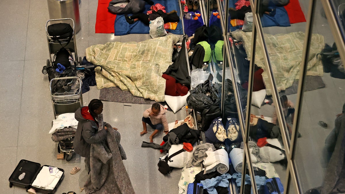 Migrants sleep at Boston airport