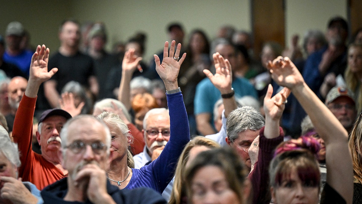 Residents raising hands