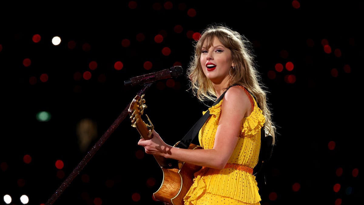 taylor swift playing guitar on stage in melbourne