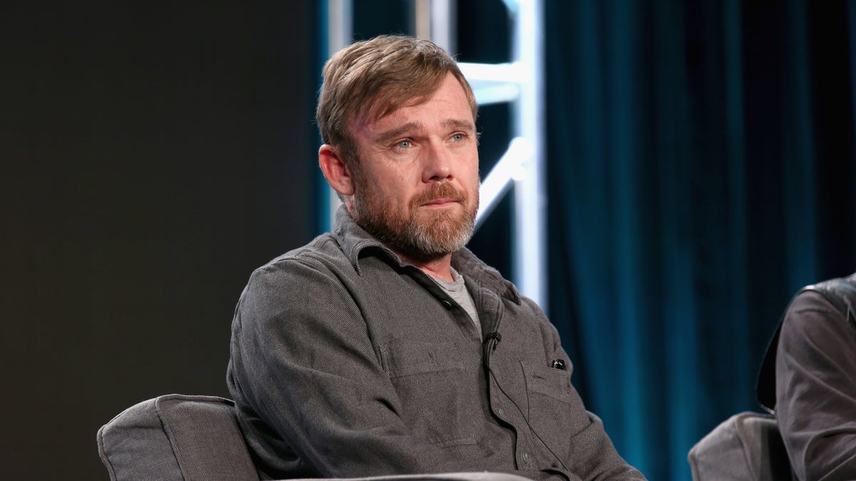 RICKY SCHRODER SITTING ON A CHAIR ON STAGE