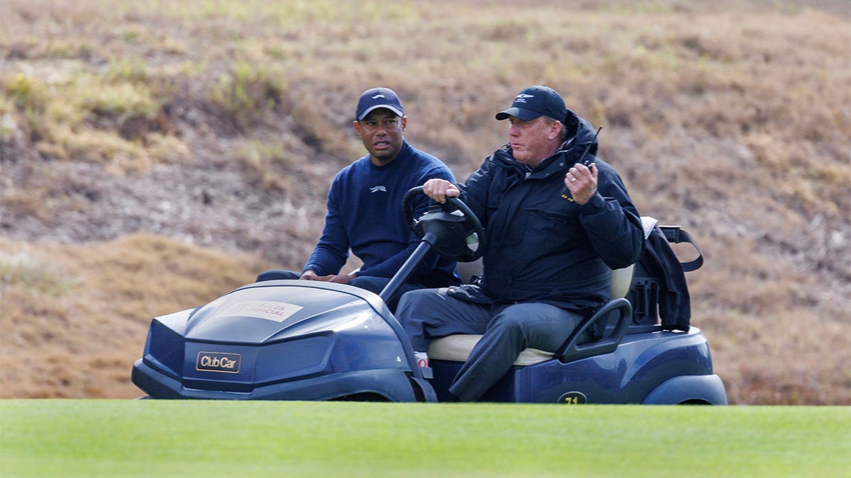 Tiger Woods is driven off in a cart