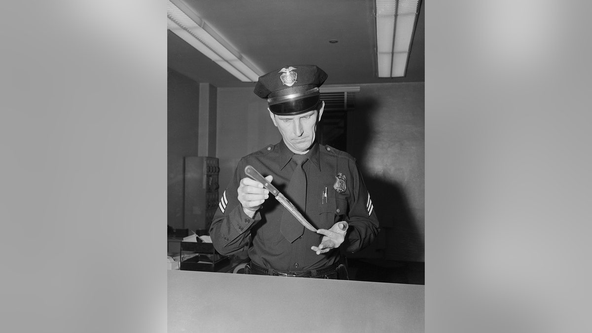 A police holding a knife