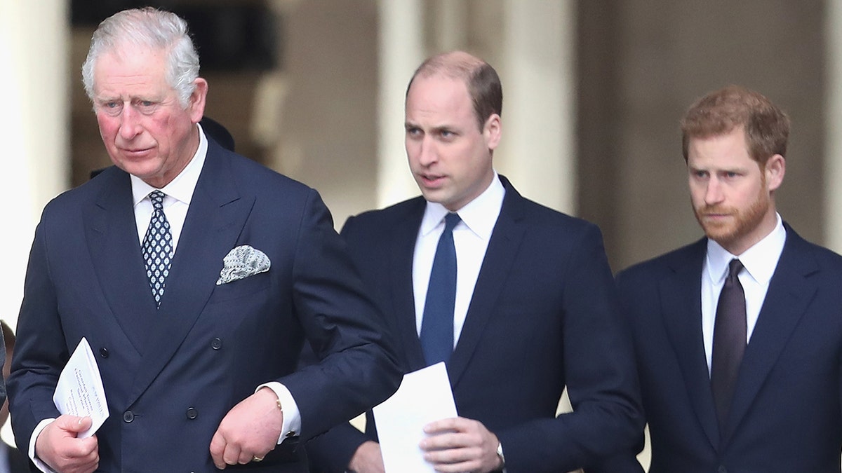 King Charles, Prince William and Prince Harry wearing matching suits as they walk together