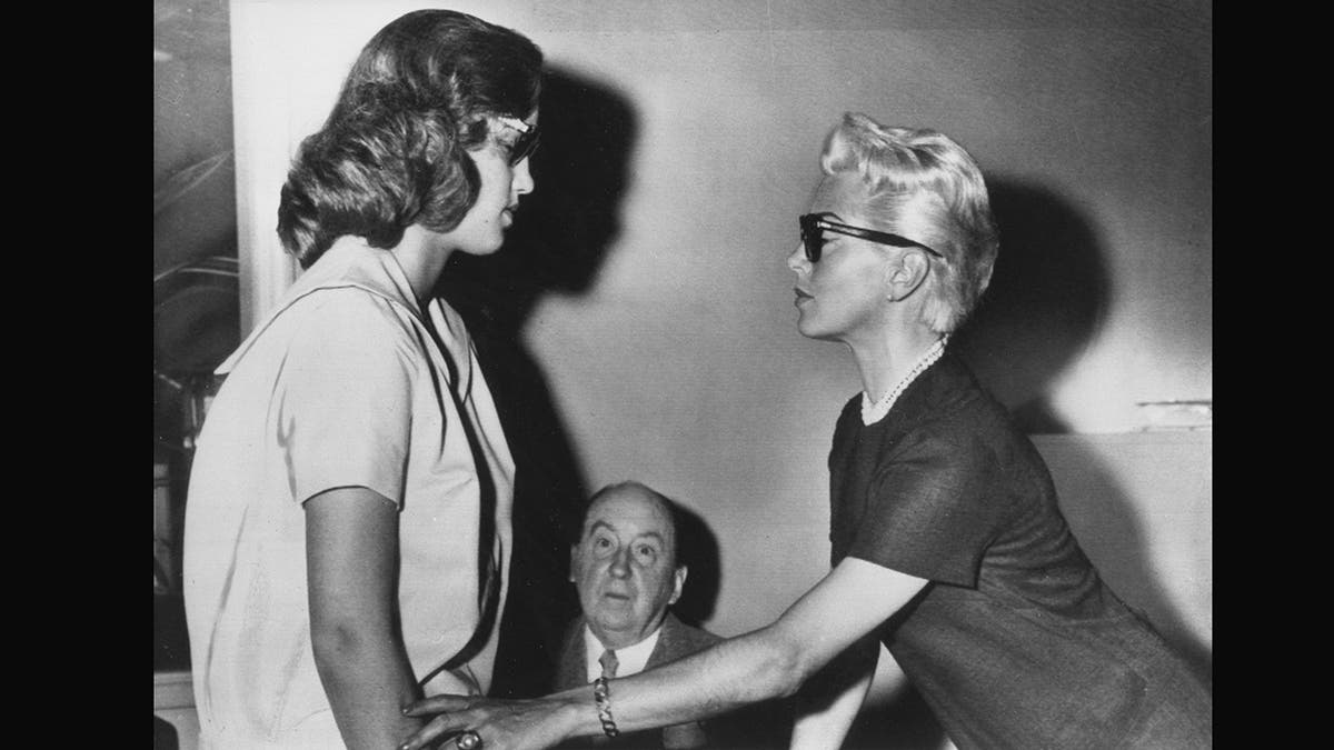 Cheryl Crane and Lana Turner looking at each other