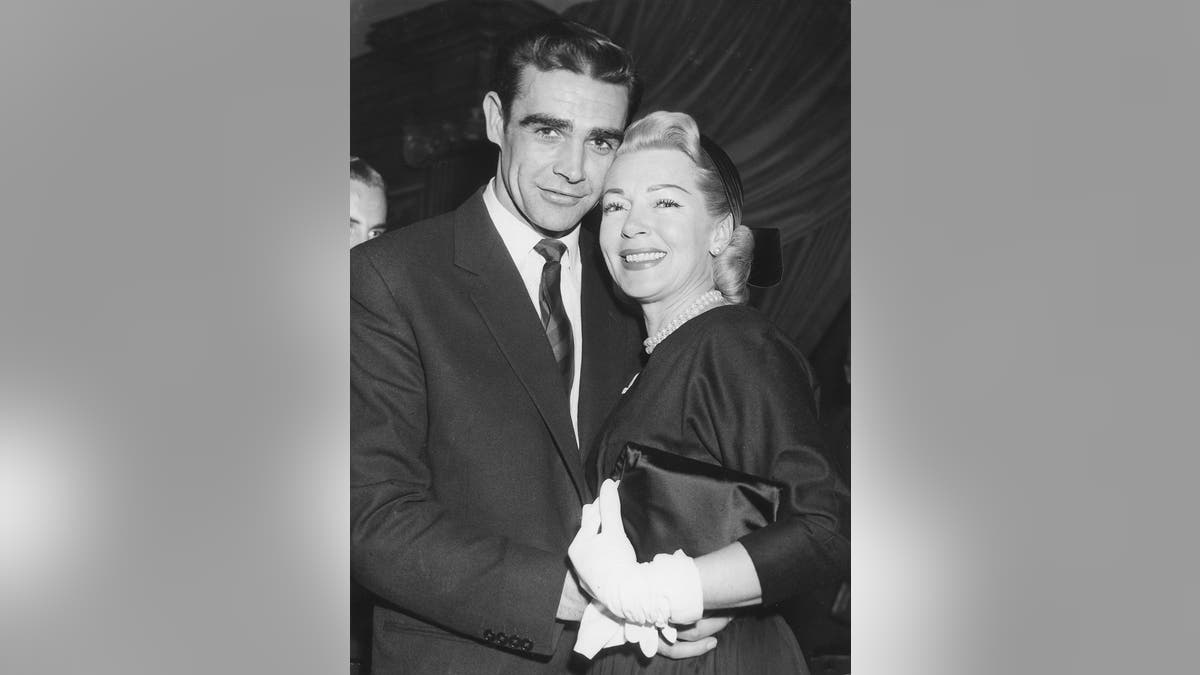 Sean Connery leaning against Lana Turner