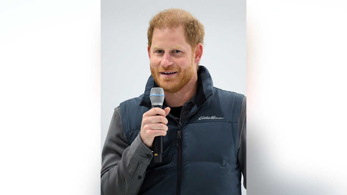 Prince Harry holding a mic