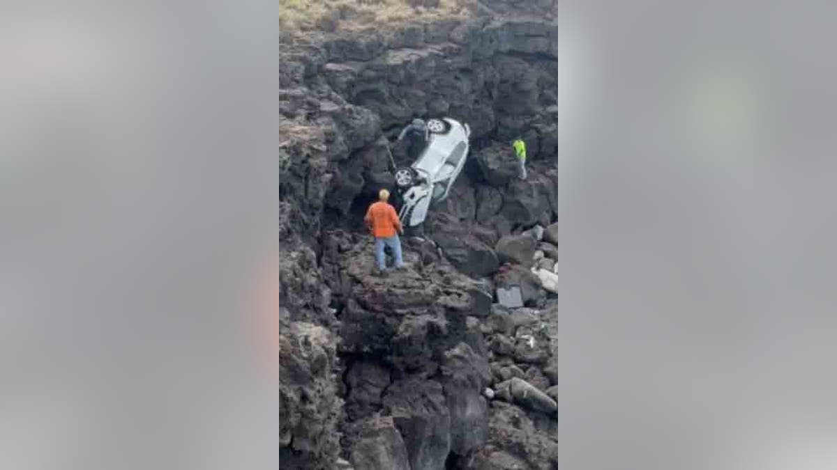 crews hauling car up cliff