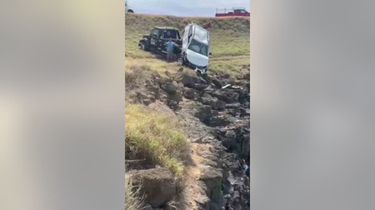 crews hauling car up cliff