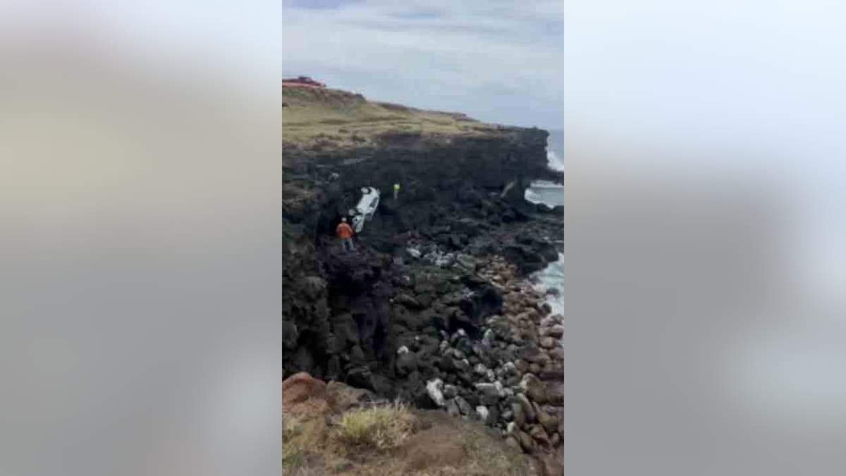 crews hauling car up cliff