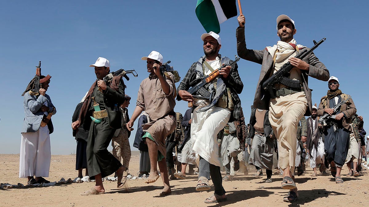 Houthi fighters march