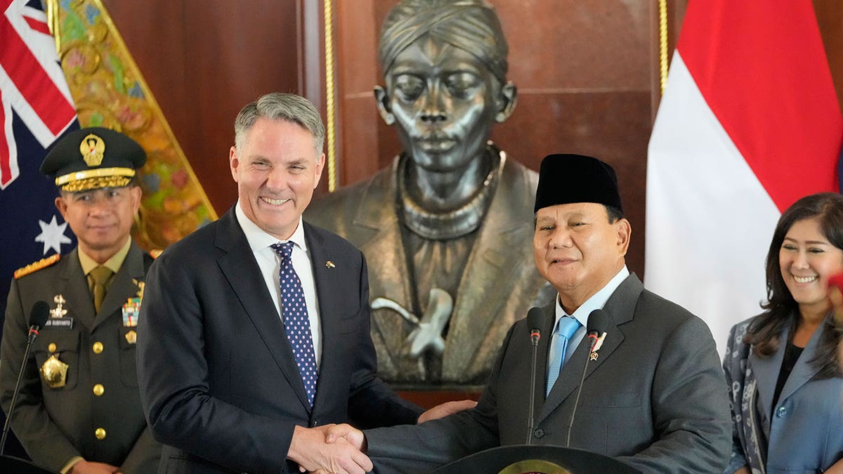 Prabowo Subianto shakes hands with Richard Marles