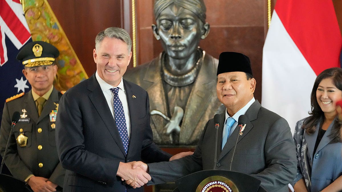 Prabowo Subianto shakes hands with Richard Marles