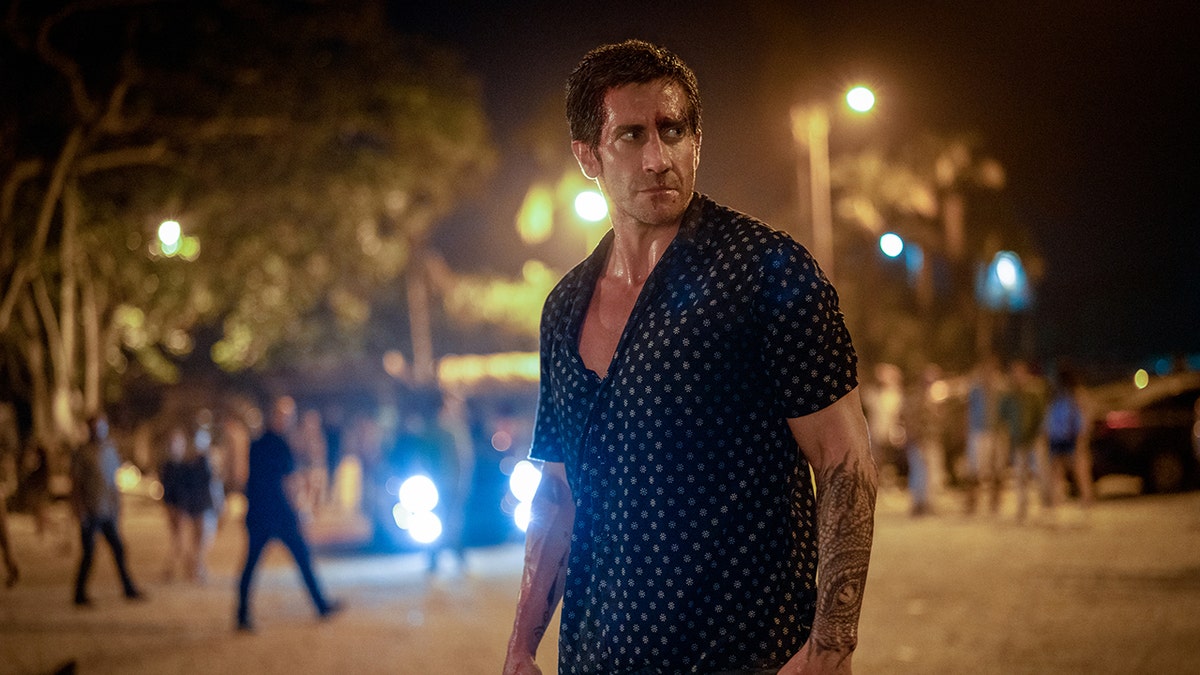 Jake Gyllenhaal on the beach in a scene from Road House.
