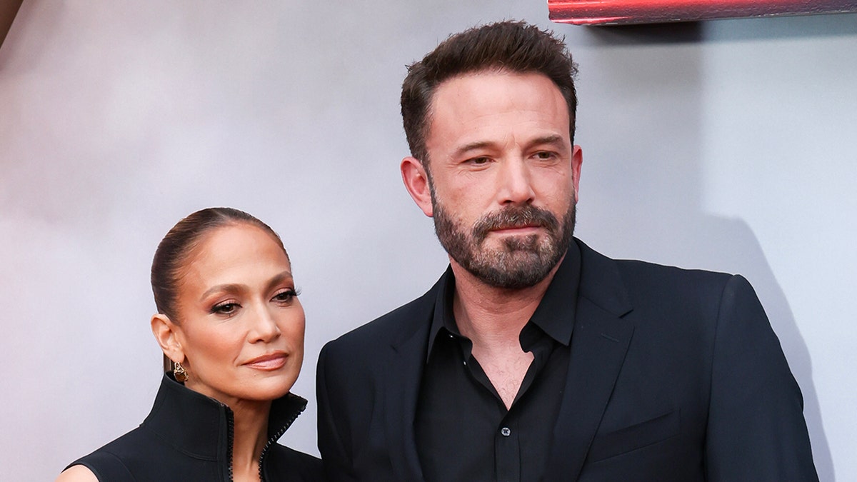 A serious looking Jennifer Lopez and Ben Affleck posing together