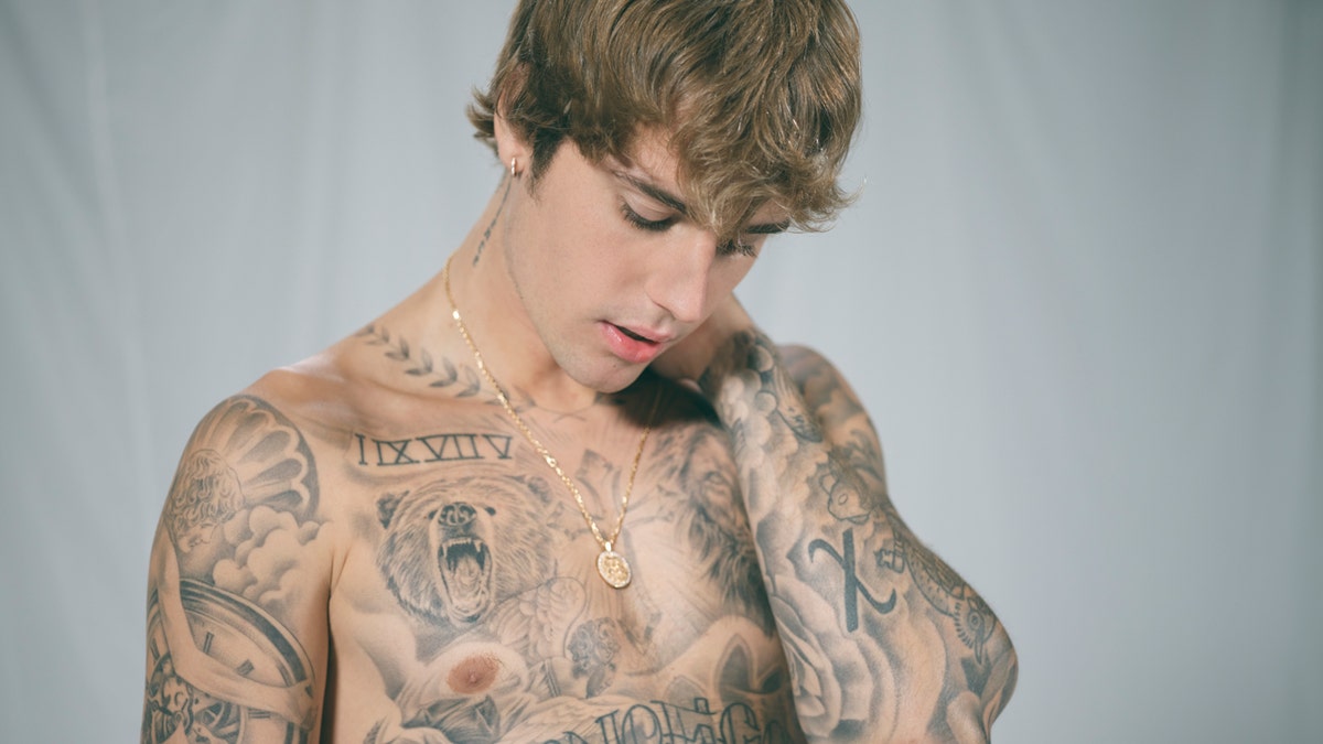 Justin Beiber poses with his tattoo exposed