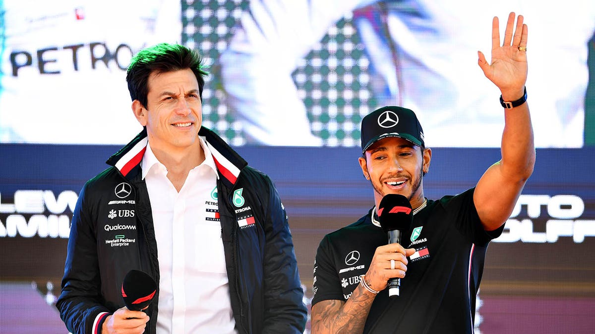 Lewis Hamilton stands next to Toto Wolff