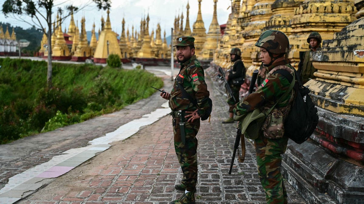 Members of the Ta'ang National Liberation Army stand guard