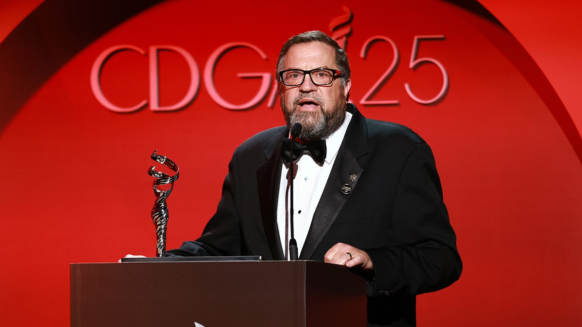 Matthew D. Loeb standing behind a podium