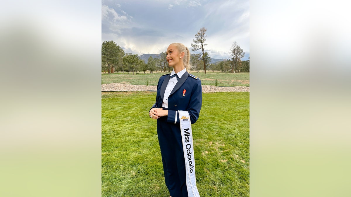 Madison Marsh in a navy suit with a Miss Colorado sash