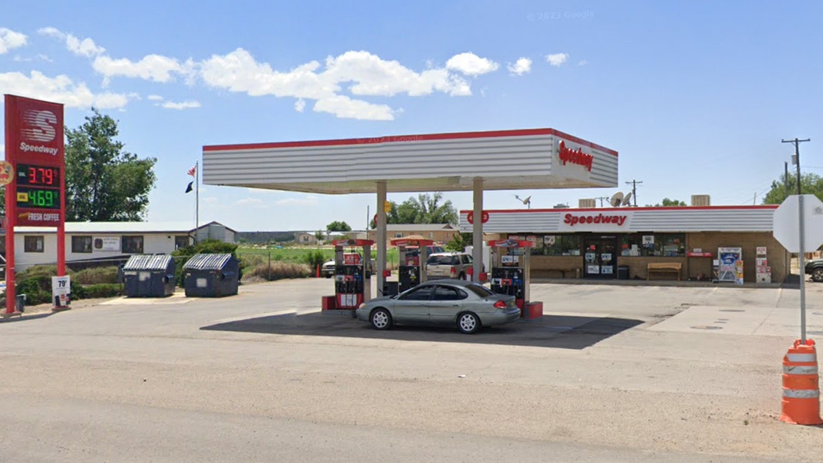 Speedway gas station, gas prices sign, car parked by gas pump, car parked by store