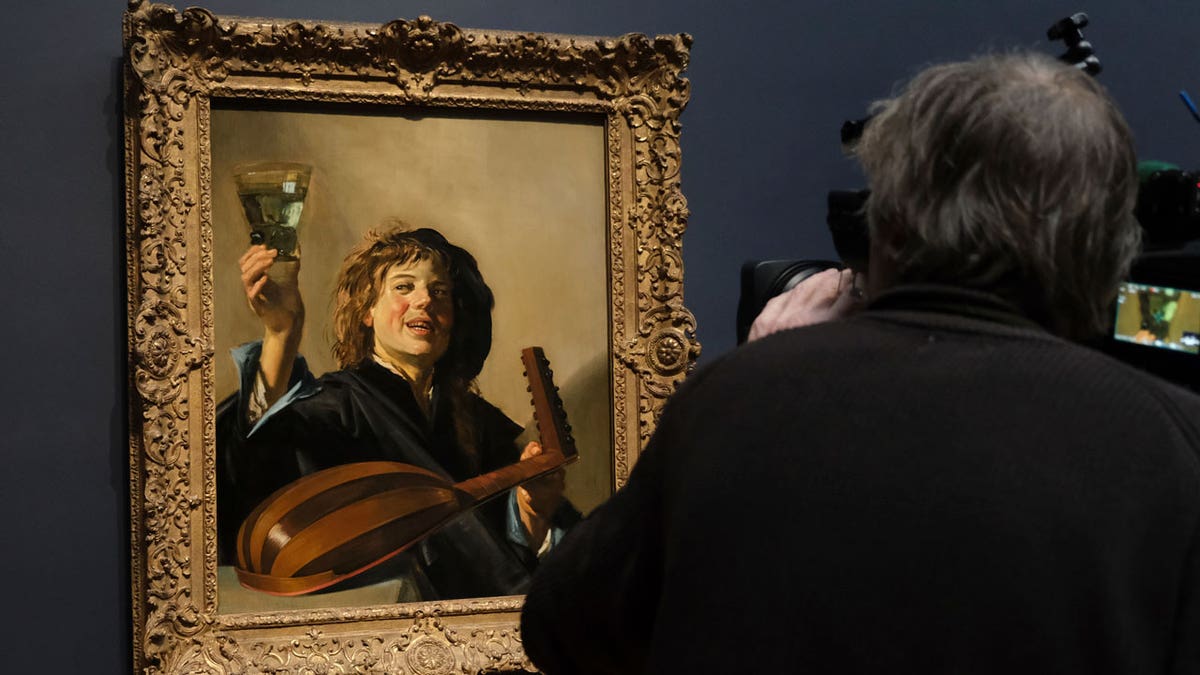 A cameraman films Frans Hals' "The Merry Lute Player" at the Rijksmuseum in Amsterdam