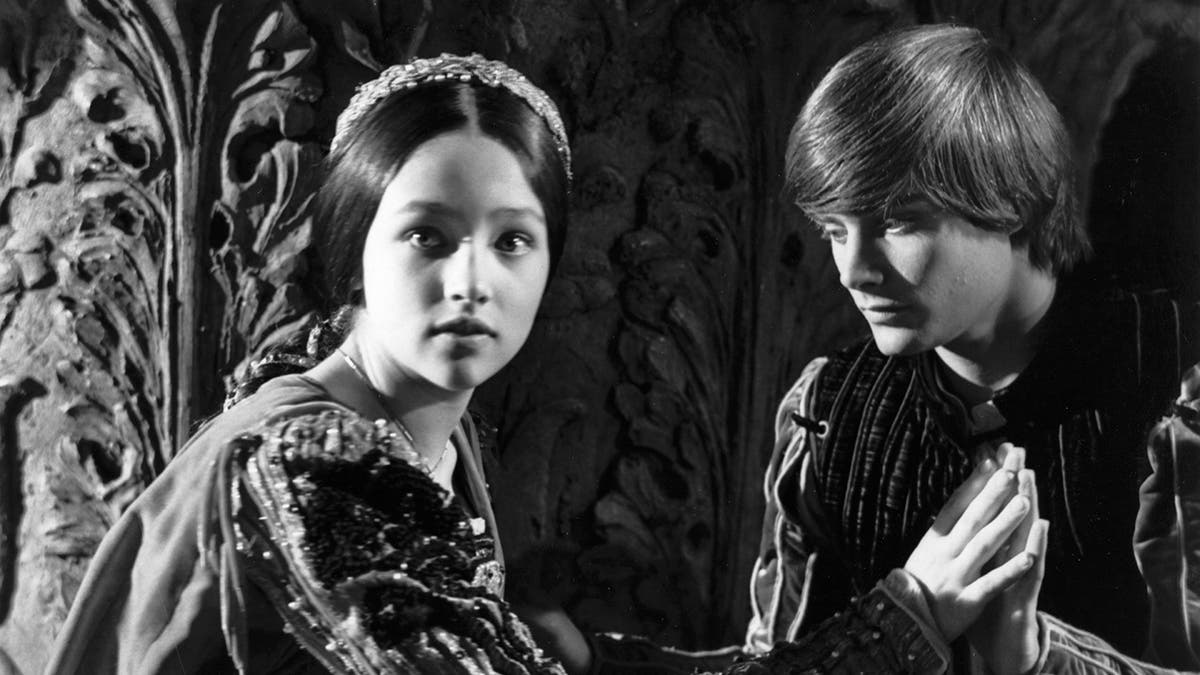 Black and white photo of Olivia Hussey and Leonard Whiting on the set of Romeo and Juliet