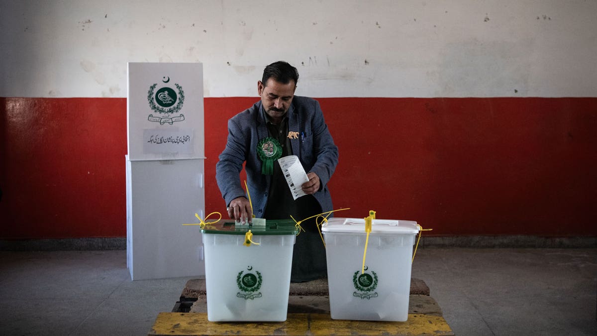 A Pakistani voter casts their ballot at a polling station