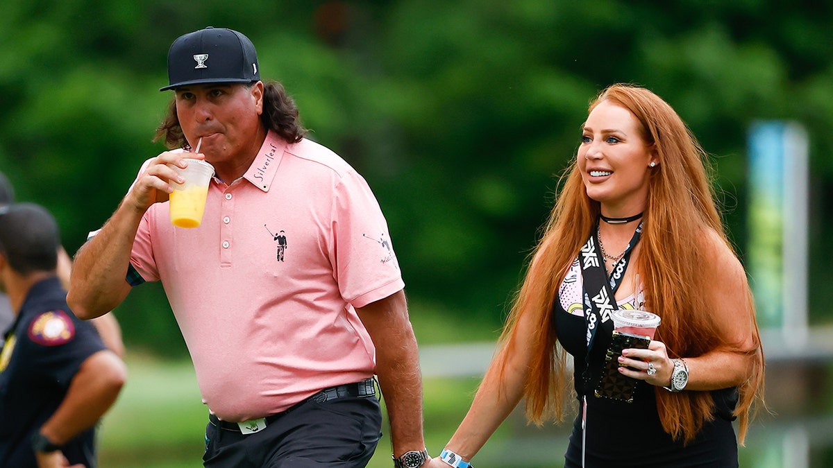 Pat Perez walks with wife, Ashley, on golf course