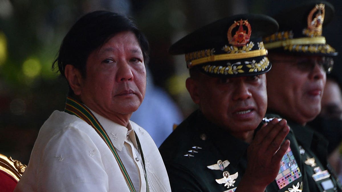 Philippine President Ferdinand Marcos Jr. listens to army chief Lieutenant General Romeo Brawner Jr.