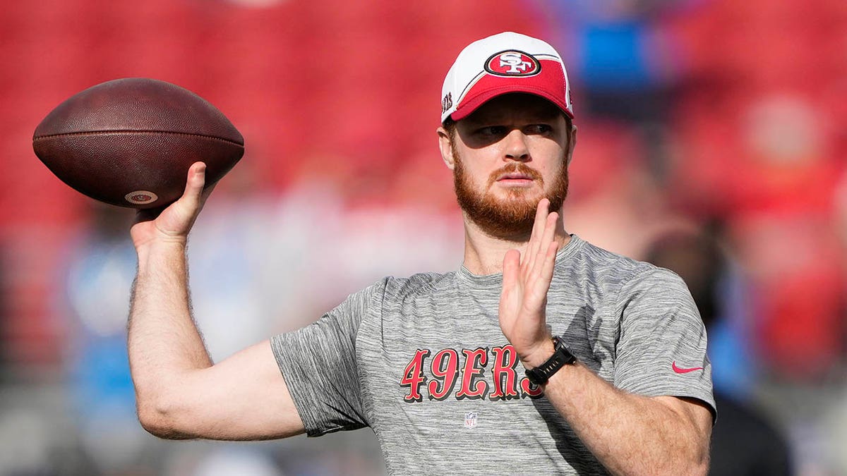 Sam Darnold warms up before a game