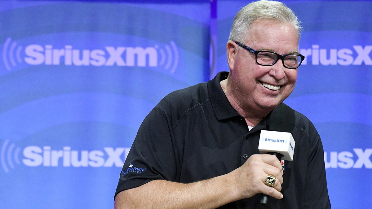 Ron Jaworski smiles with microphone in hand