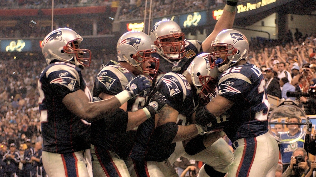 (2/1/04Houston, TX) Super Bowl XXXVIII. New England Patriots. ( Patriots mob Antowain Smith after he scored in the fourth020104patsmjs-staff photo by Michael Seamans. Saved in photo Monday/cd)