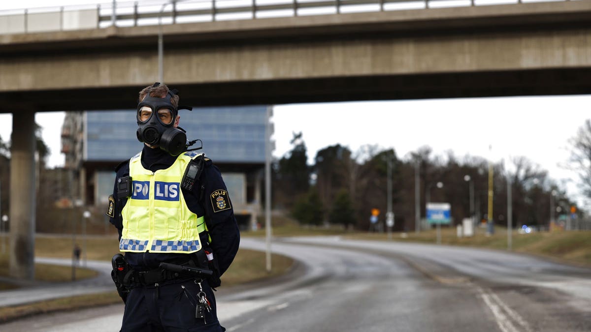 A police officer with a gas mask