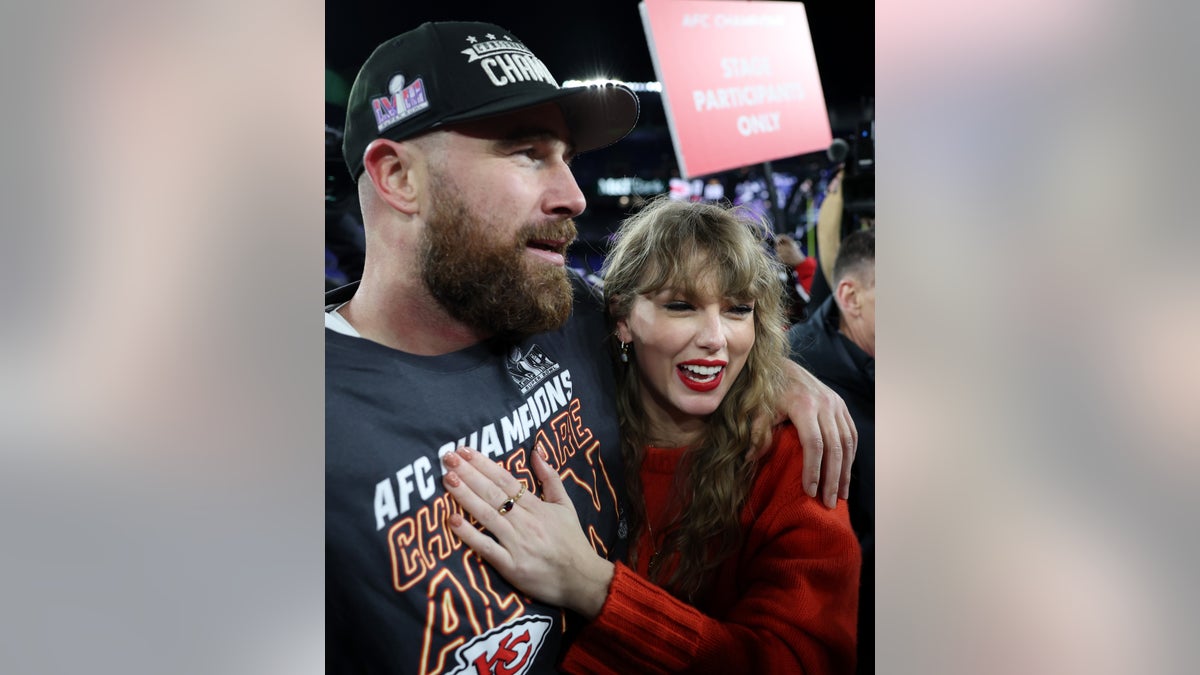 Taylor Swift putting her hand on Travis Kelce's chest