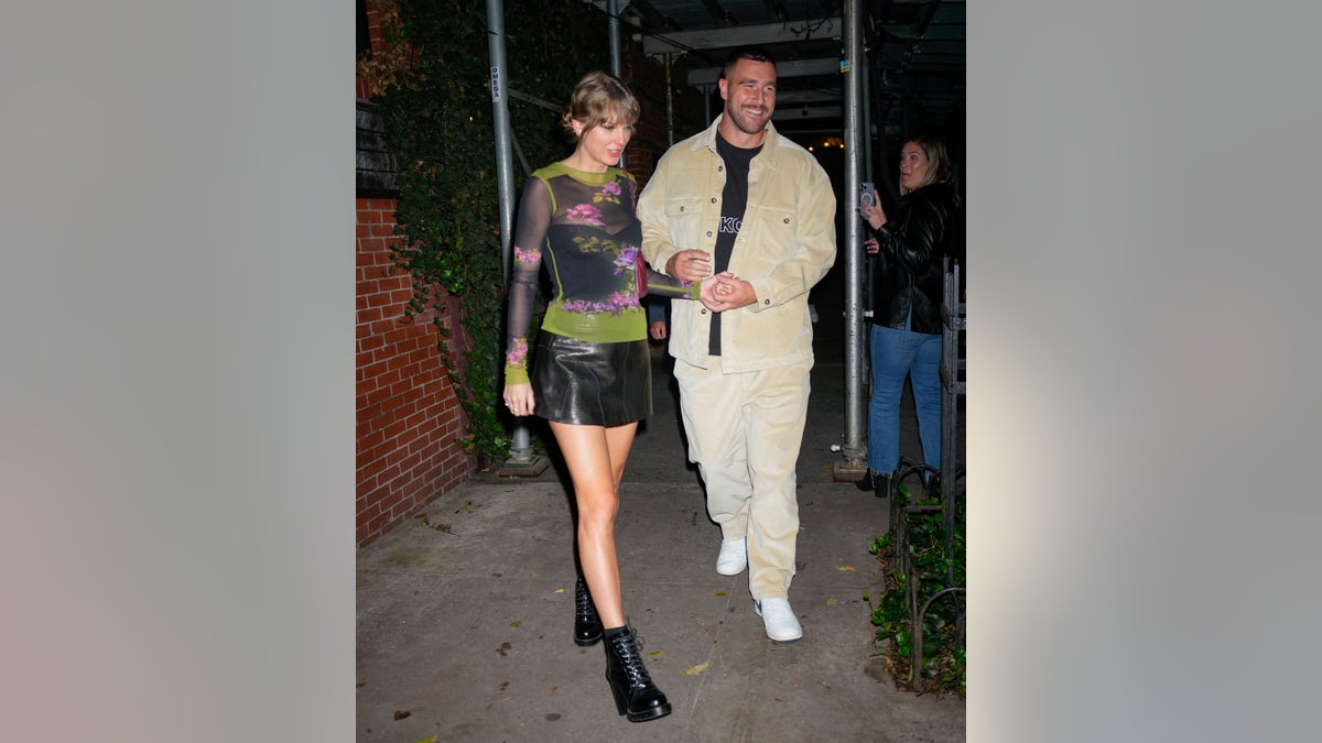 Taylor Swift and Travis Kelce walking hand in hand