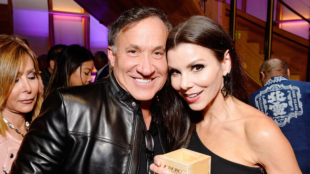 Dr. Terry Dubrow and Heather Dubrow leaning in together